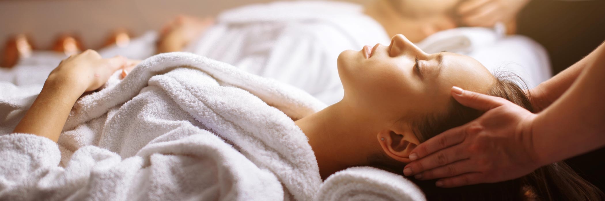 Image of woman having a head massage at a spa.